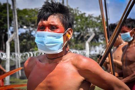 Shirtless man wearing a medical face mask