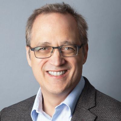 Headshot of Brian Miller, Executive Director, Nonprofit VOTE, in a light blue shirt and brown jacket.