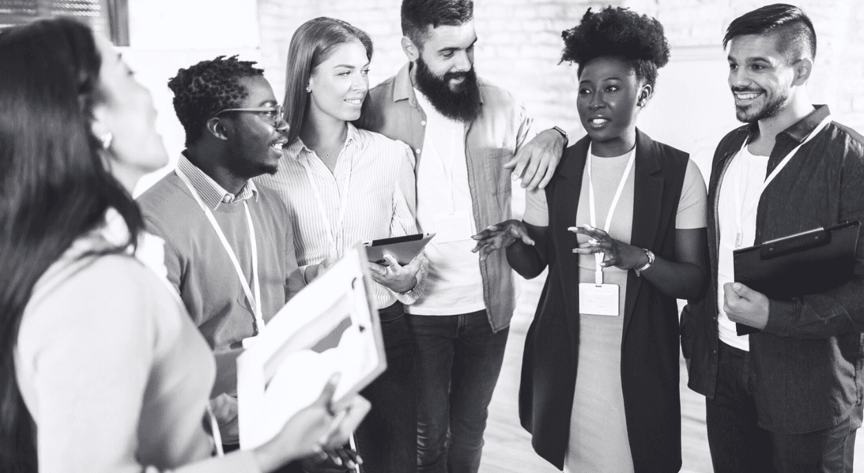 A group of diverse colleagues talking to each other.