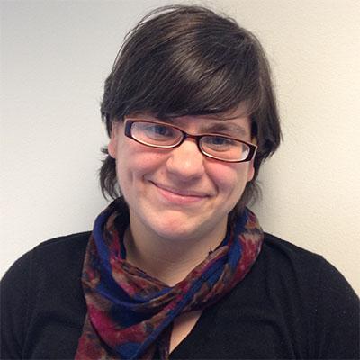 Headshot of Katherine Ingersoll, director of communications, engagement, and strategy at SMU DataArts, in glasses, a black top and a multi-colored scarf.