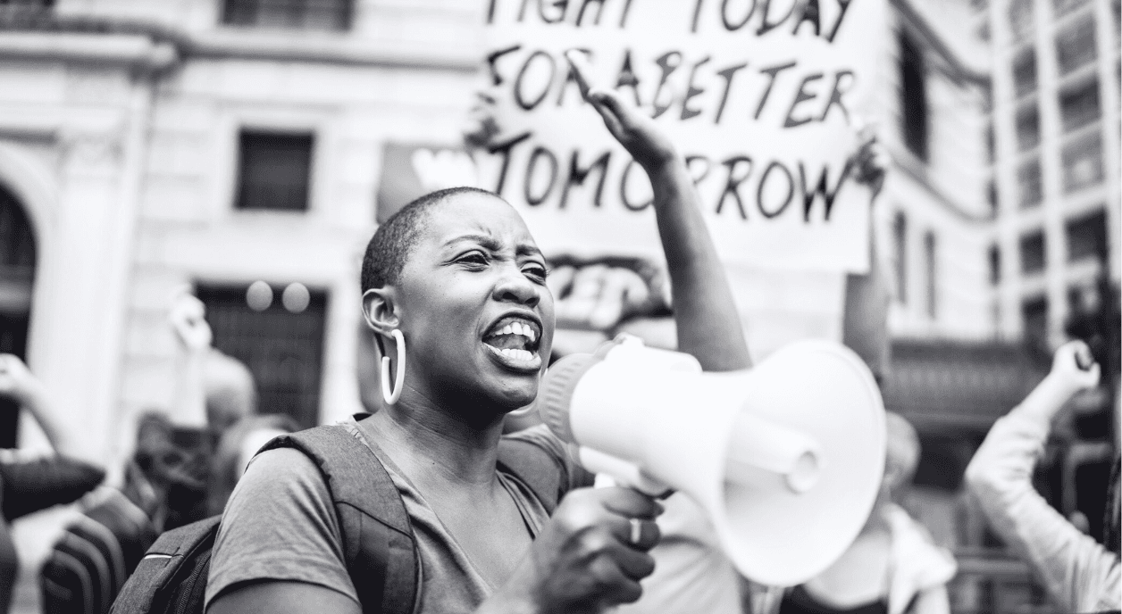 A Black woman with other activists at a protest.