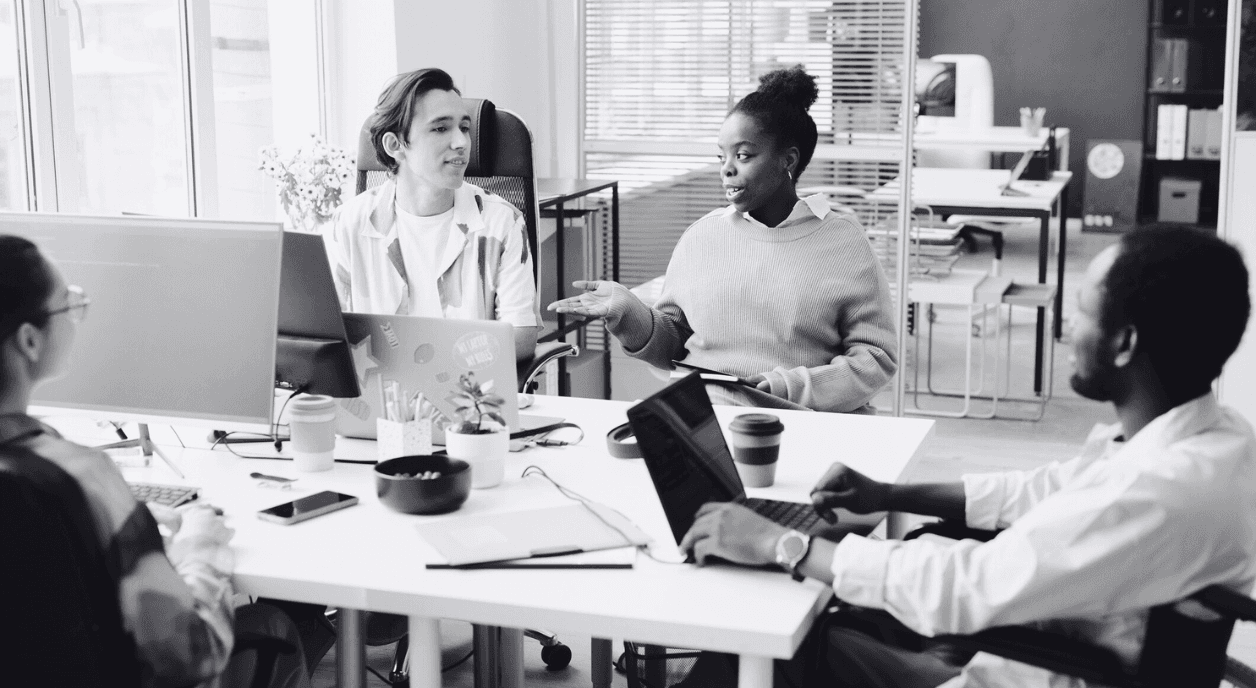 A group of diverse colleagues having a conversation about DEI strategies.