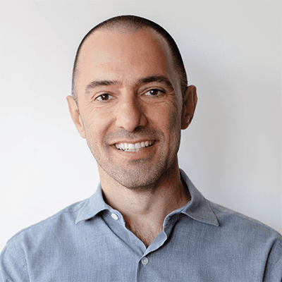 Headshot of Crist Khachikian, founder and CEO of Idea9, in a light blue shirt.