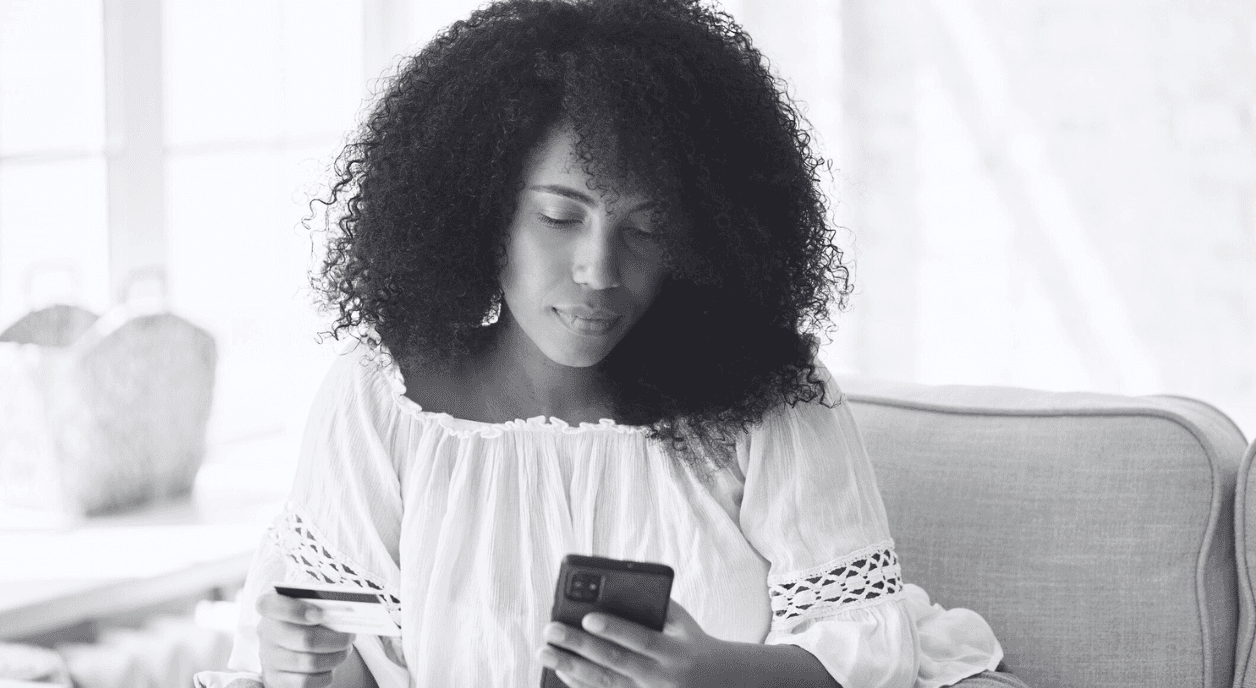 A Black woman donating on her phone.