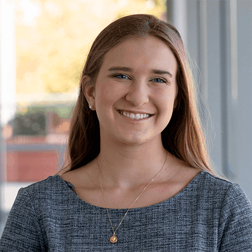 Headshot of Katrina Frei-Herrmann, a senior associate consultant in The Bridgespan Group’s Boston office, in a blue dress.