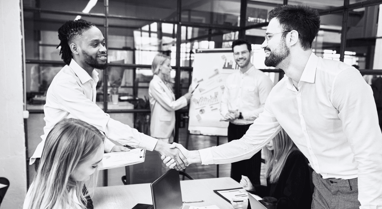 Businessmen shaking hands during a meeting.