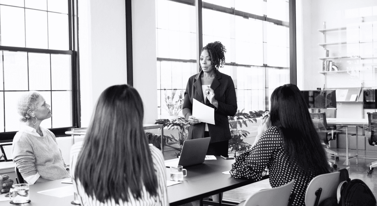 A nonprofit leader talking to her team about organizational planning.